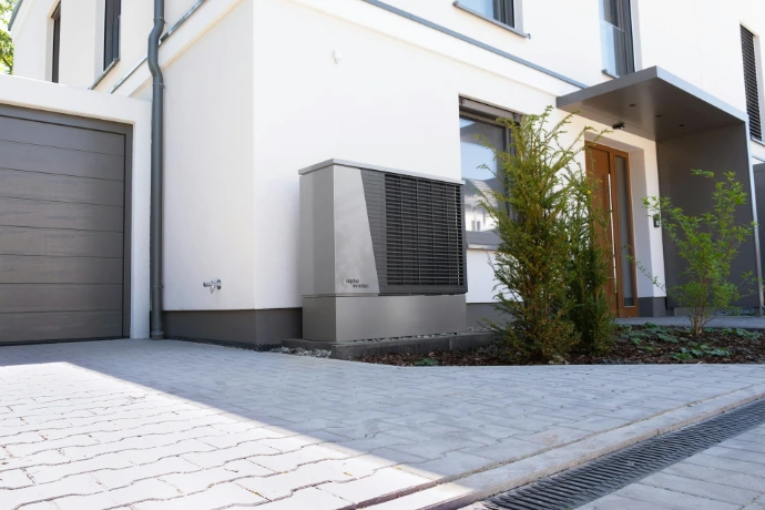 Modern house exterior with heat pump unit.